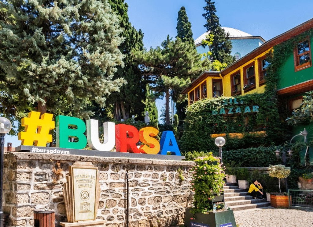 Istanbul to Bursa & Uludag Day Tour: Lunch, Cable Car Option Bursa sign on a wall with a building in the background