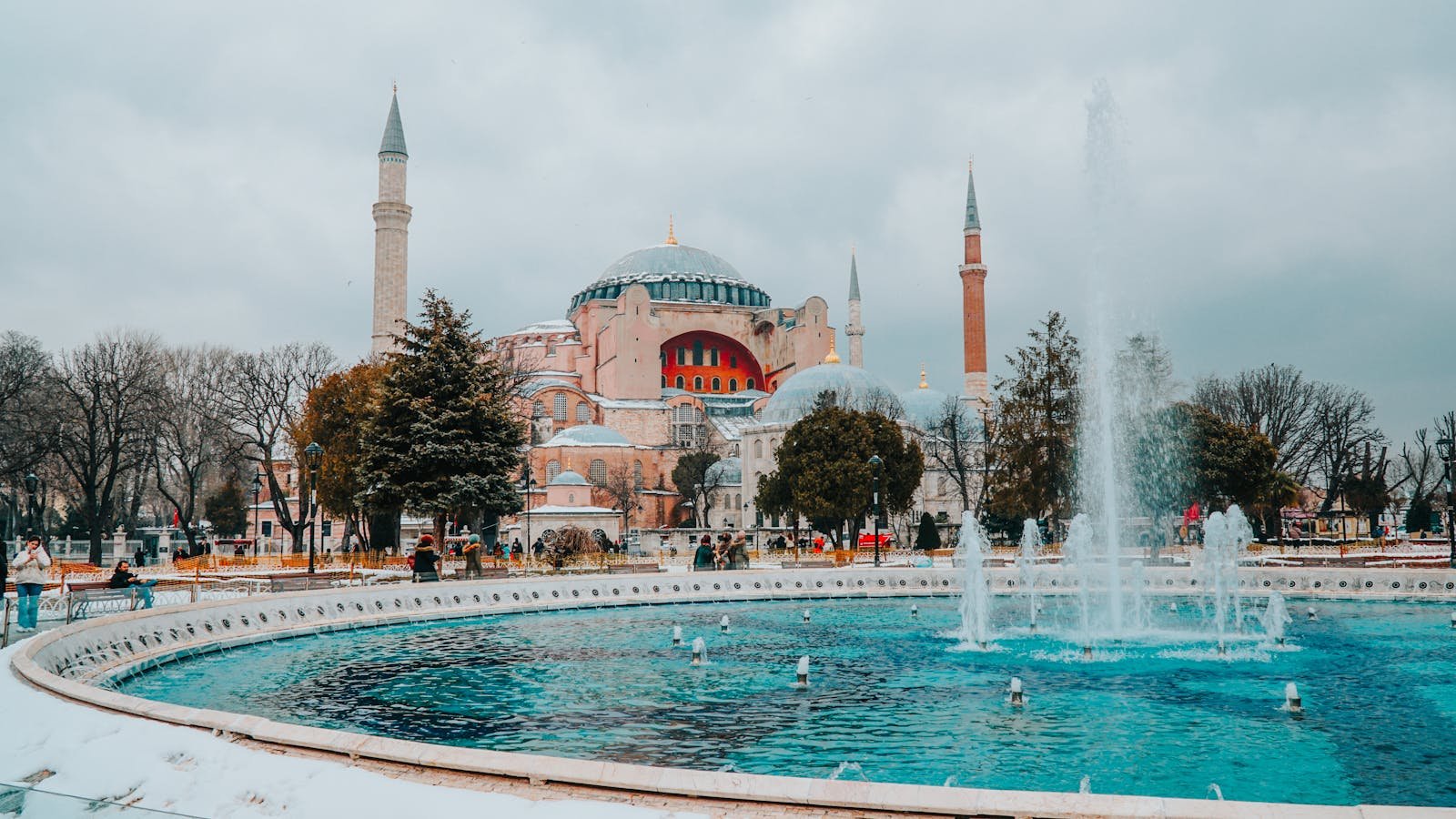 Istanbul's iconic Hagia Sophia with a vibrant fountain during winter.