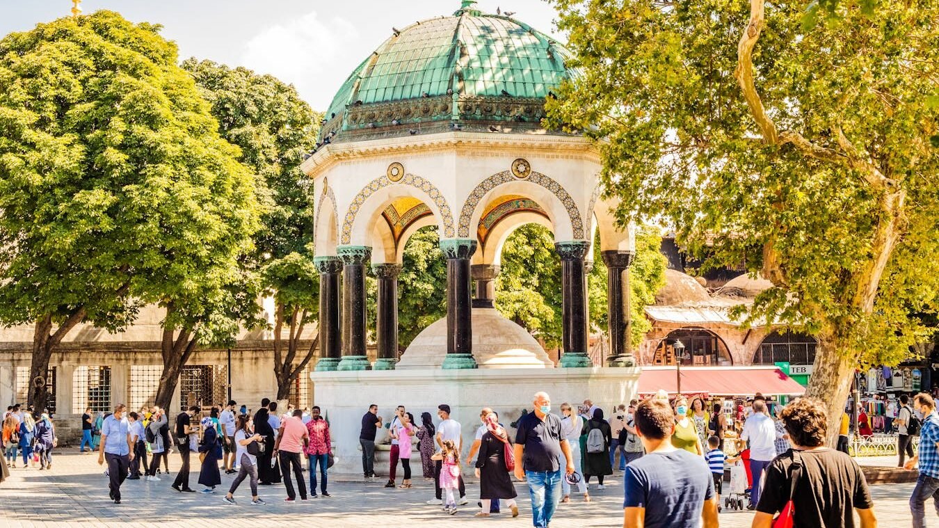 German Fountain in Sultanahmet Square, Istanbul, with people walking around.