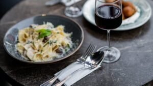 Elegant outdoor dining setup with wine, pasta, and appetizers in Istanbul.