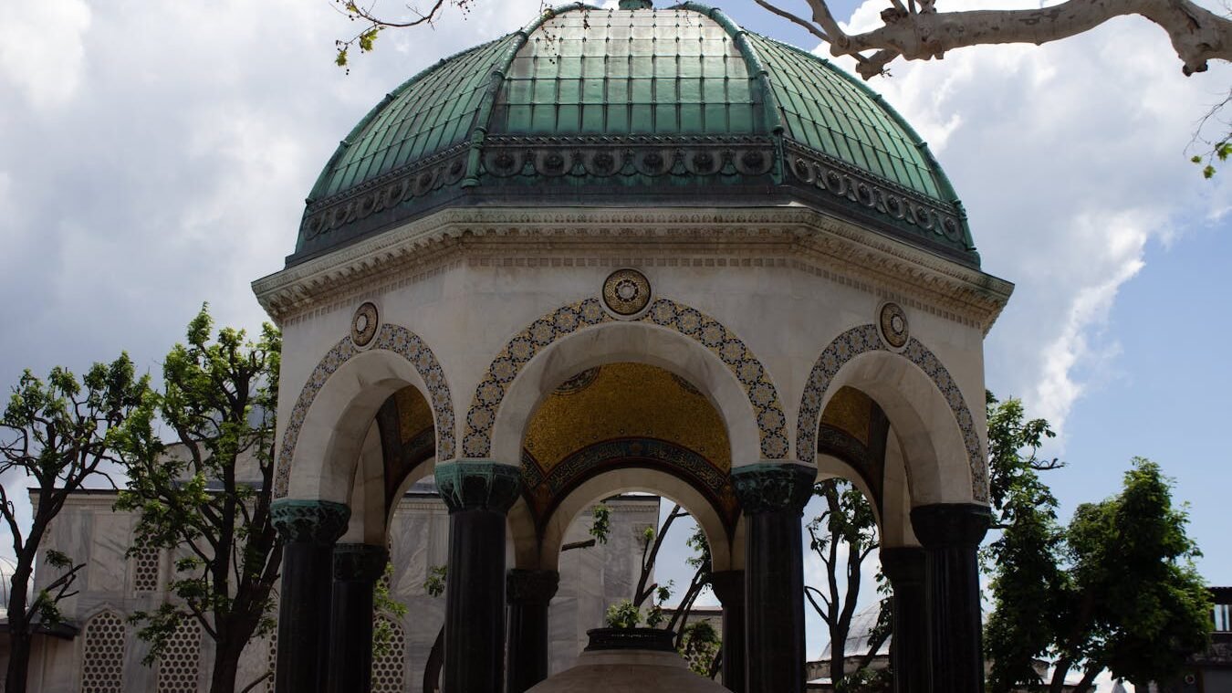 View of the beautiful German Fountain in Istanbul, showcasing its intricate architecture and green dome.