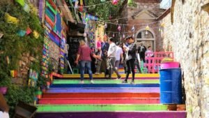 people walking climbing on multicolored stairs