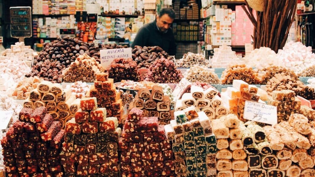 man in black jacket standing in front of assorted color and pattern plastic packs