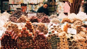 man in black jacket standing in front of assorted color and pattern plastic packs