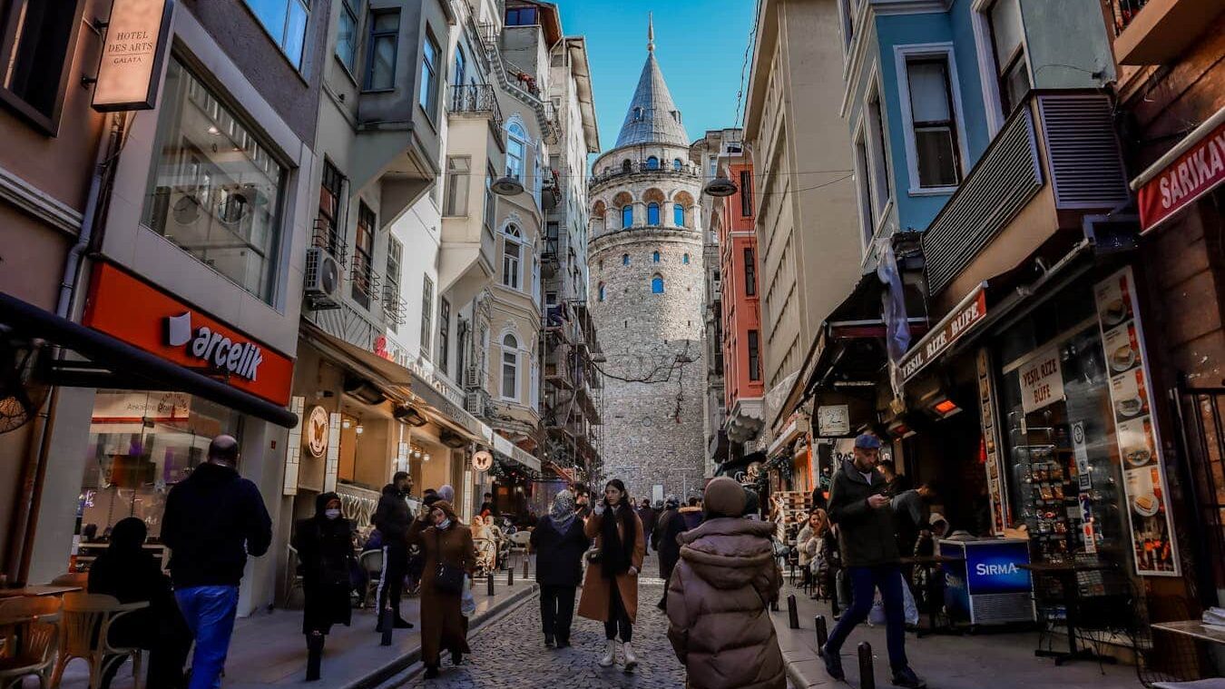 Bustling street scene of Galata Tower in Istanbul showcasing daily life and historic architecture.