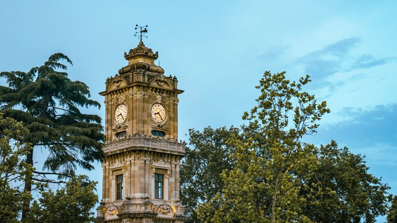 Explore the iconic Dolmabahçe Clock Tower in İstanbul, Türkiye, showcasing Ottoman architecture.