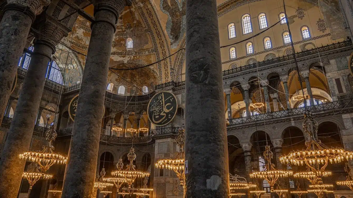 15 Things You Didn't Know About Hagia Sophia the interior of a large building with chandeliers