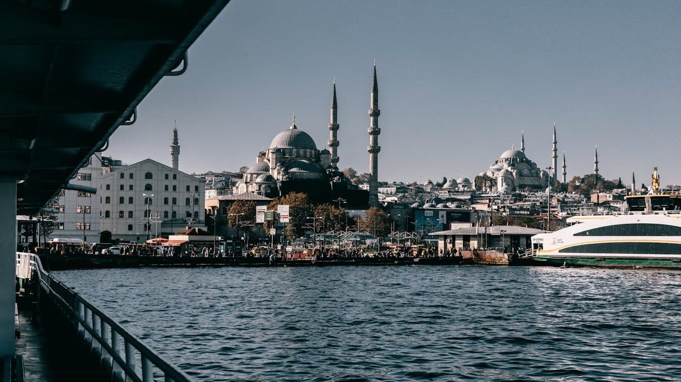 View of Istanbul's waterfront with iconic mosque and ferry, capturing the city's vibrant culture and architecture.