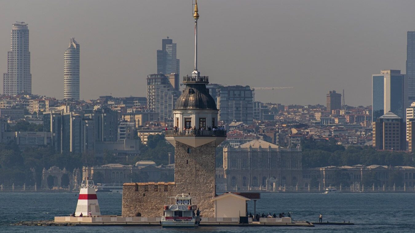 Maiden's Tower - a large body of water with a lighthouse in the middle of it