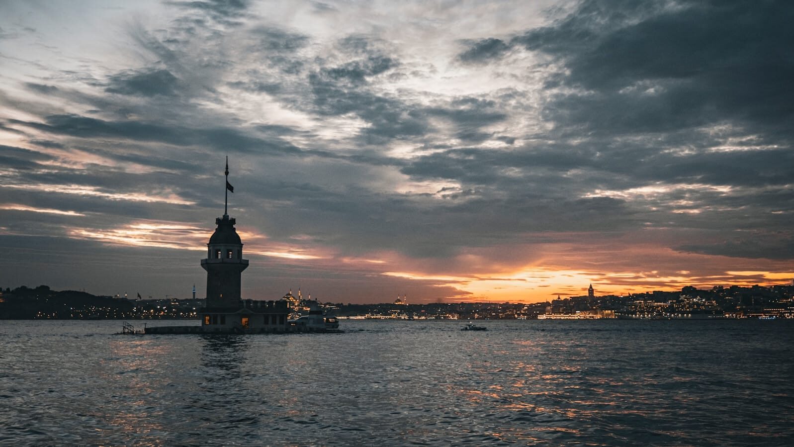 A large body of water with a clock tower in the middle of it