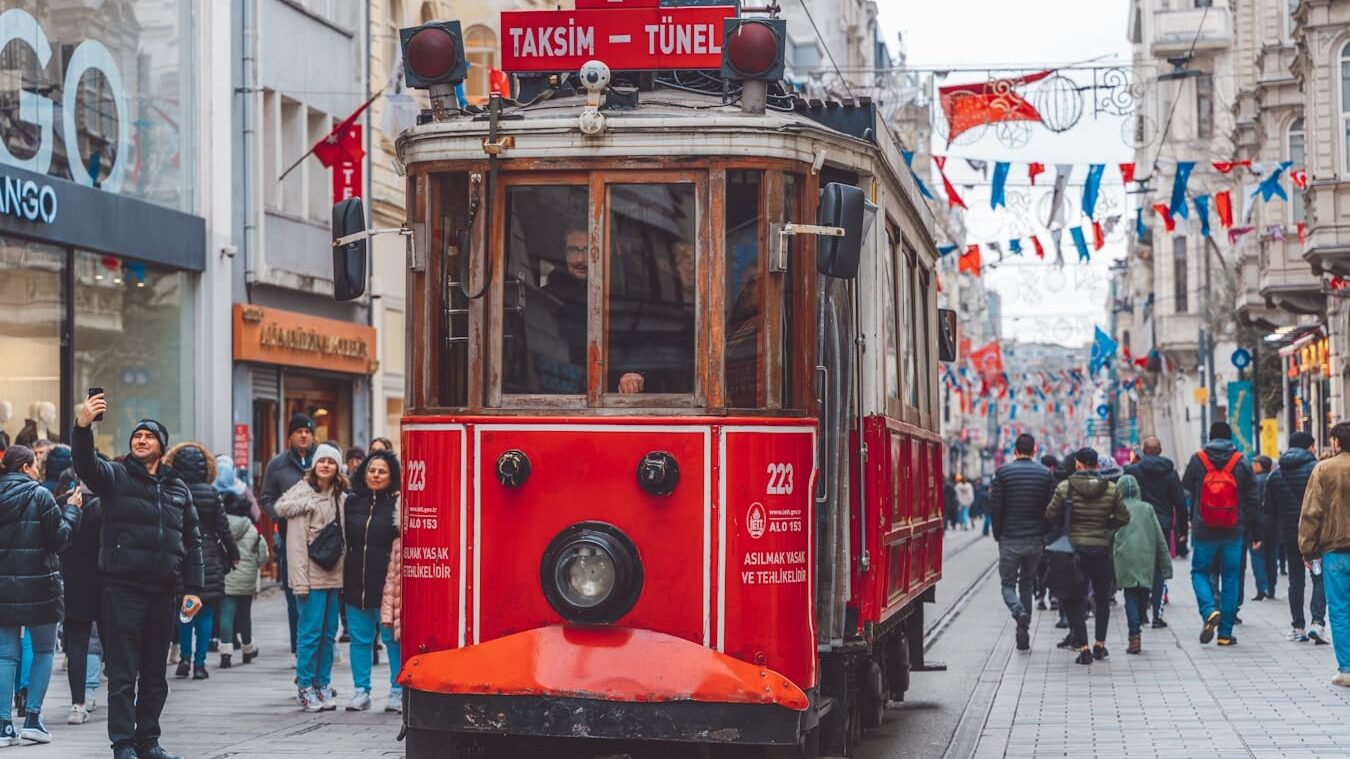 a red trolley car on a city street
