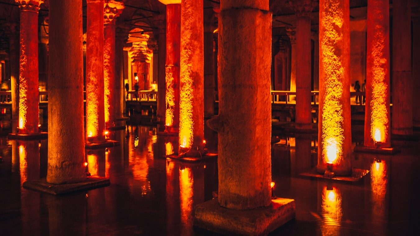 brown concrete pillar near body of water during night time