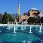 a large building with a fountain in front of it