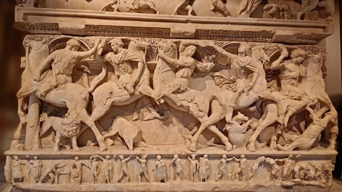 a stone sculpture of a group of people riding horses