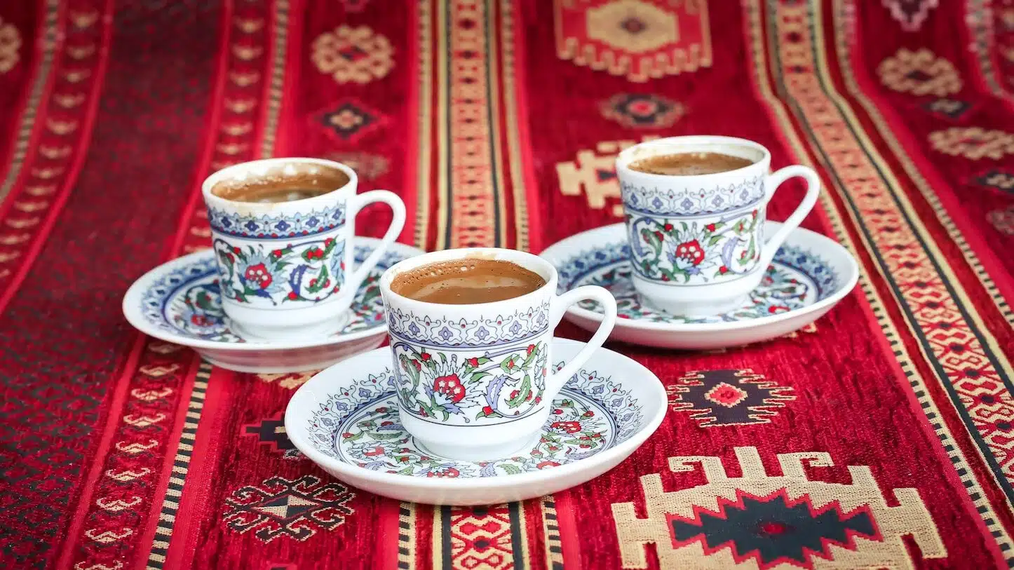 three multicolored floral ceramic turkish cups and saucers