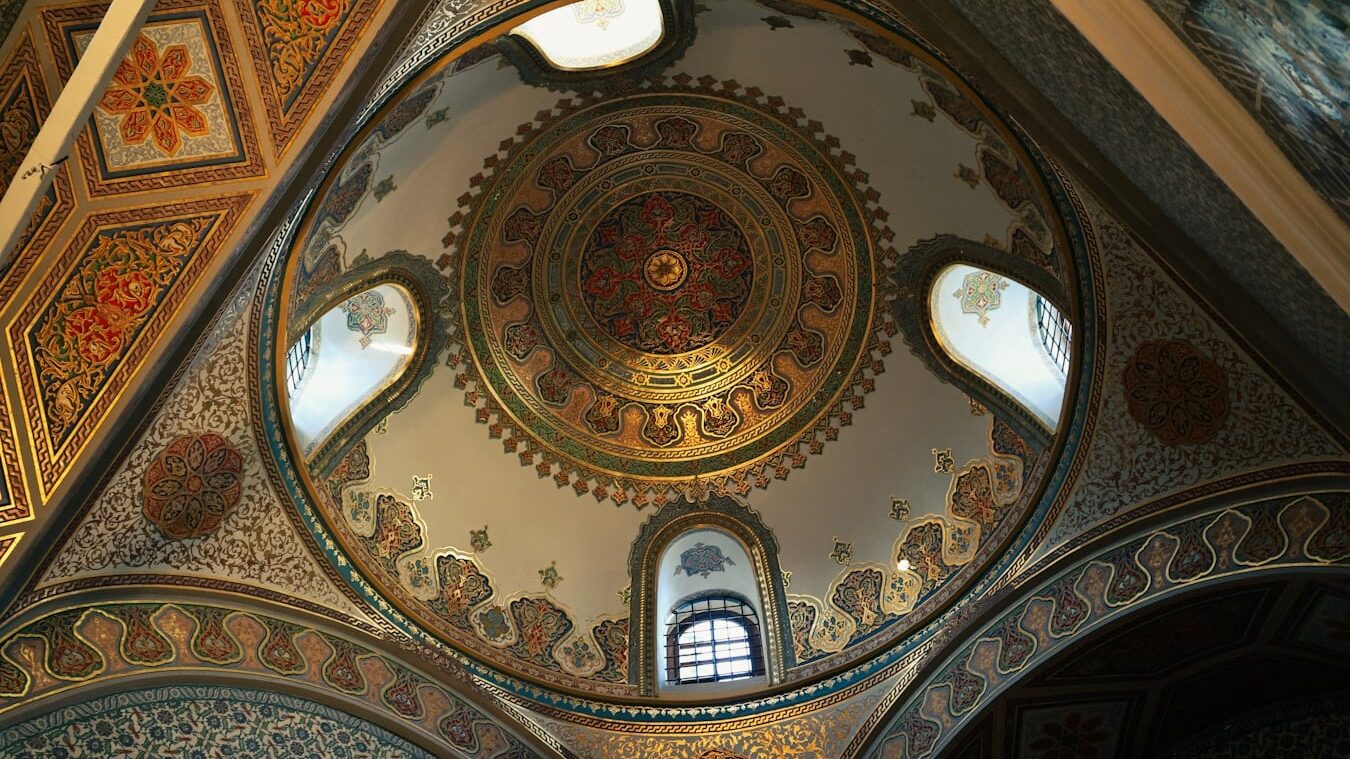The inside of a church with a dome and stained glass windows