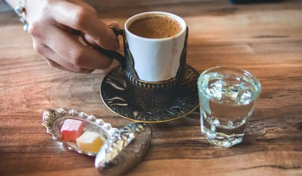 white ceramic cup near mug