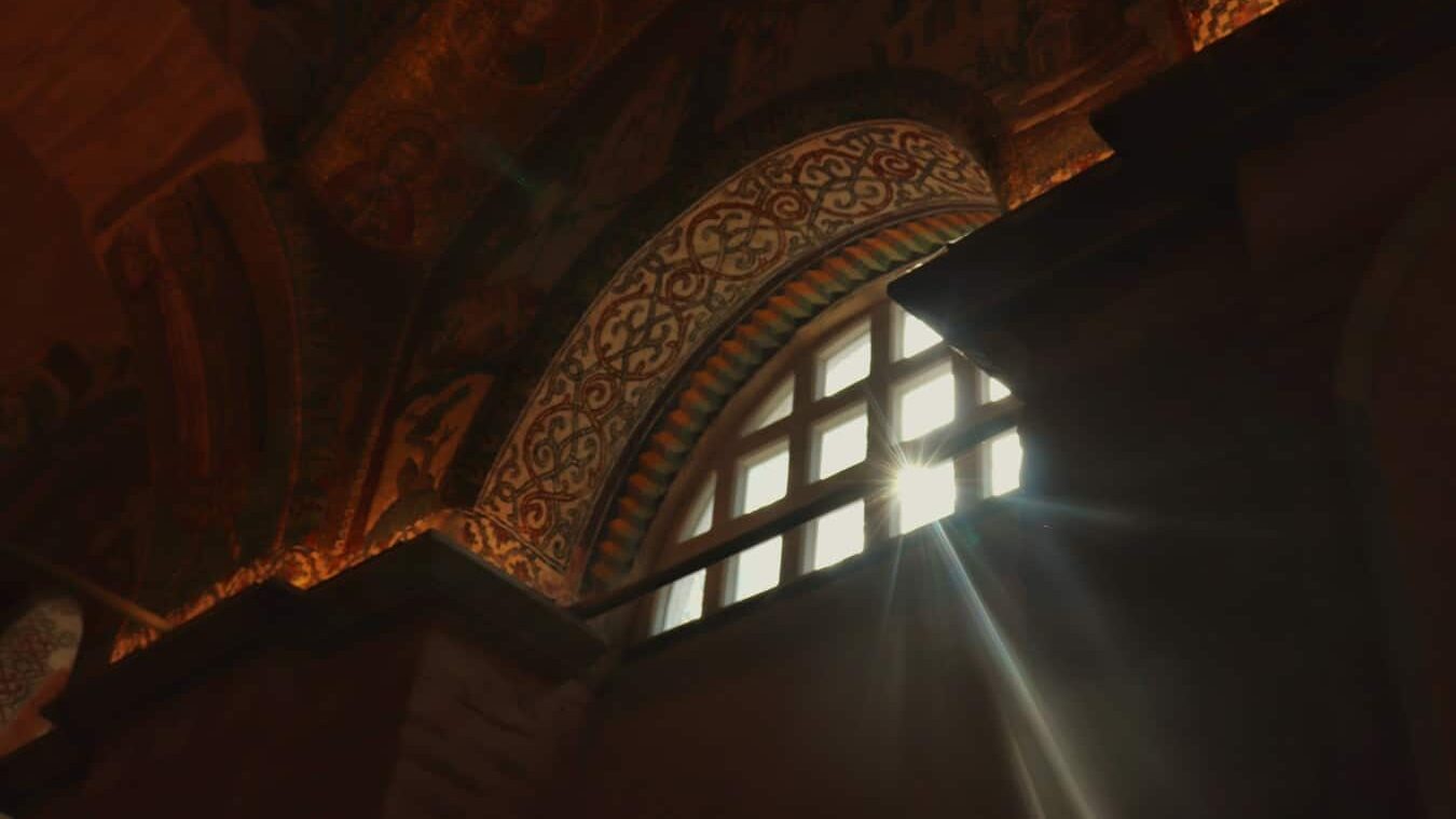 A light shines through a window in a building