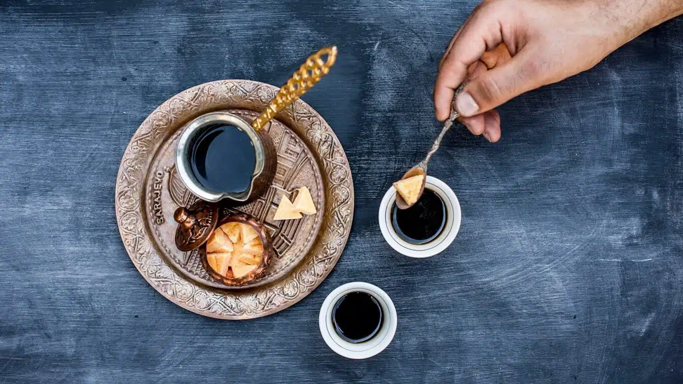 brown and white ceramic plate with black ceramic Turkish coffee cup