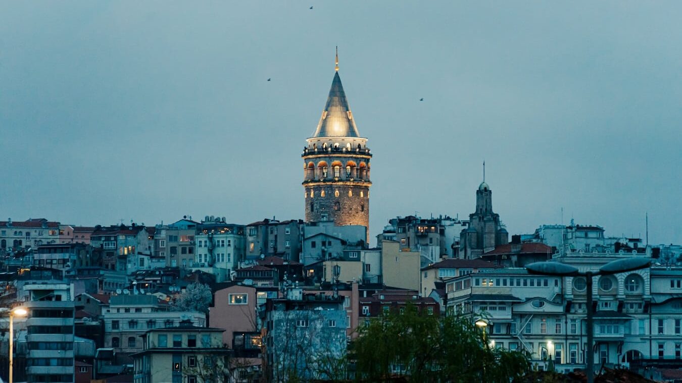 a very tall clock tower towering over a city