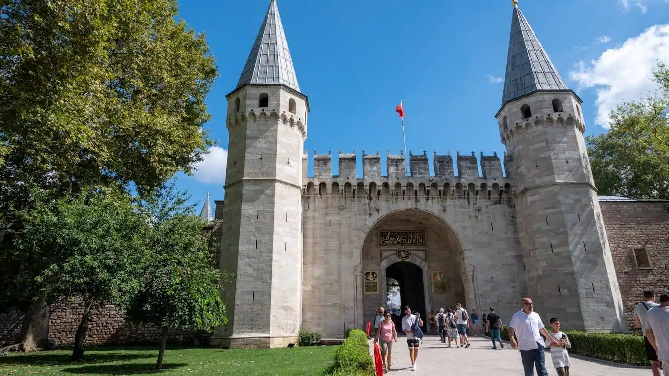 Top Museums You Must Visit Near Hagia Sophia in 2025 a group of people walking outside of a castle with Topkapı Palace in the background