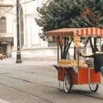 people riding on red and black auto rickshaw on road during daytime
