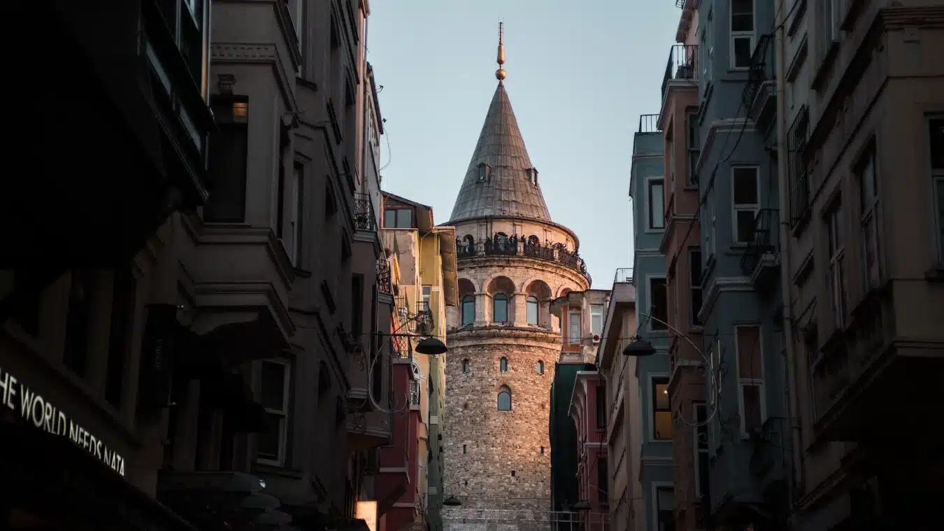 a tall tower towering over a city filled with tall buildings