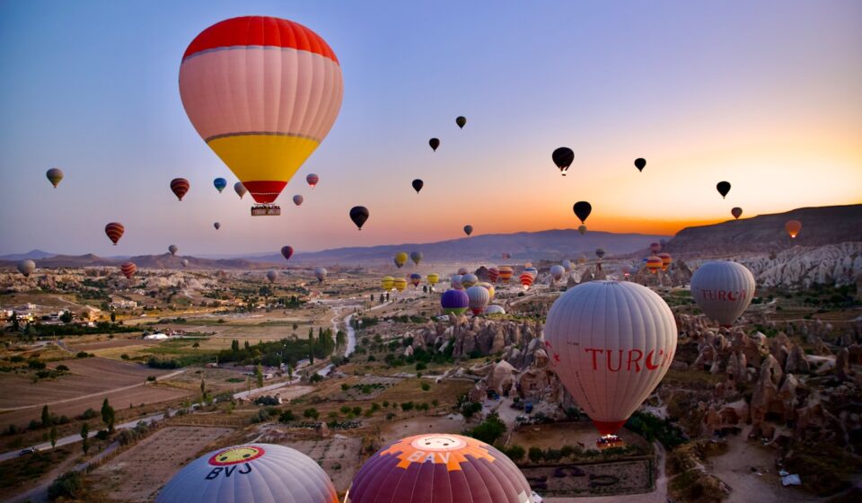 Cappadocia: Fairy Chimneys, Underground Cities and Hot Air Balloons a group of hot air balloons in the sky