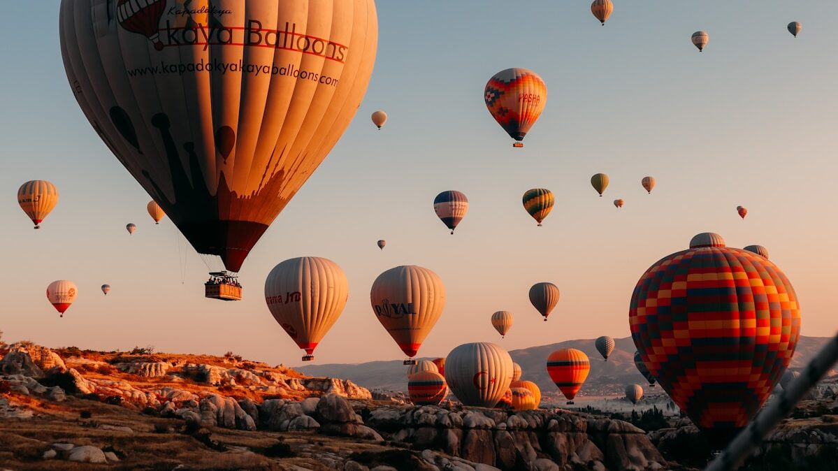 Unforgettable Things to Do in Cappadocia hot air balloons on brown field during daytime