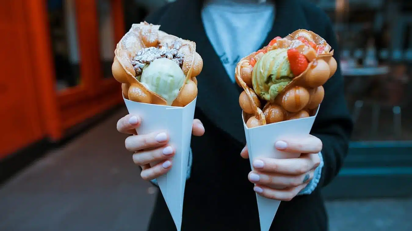 person holding two ice creams