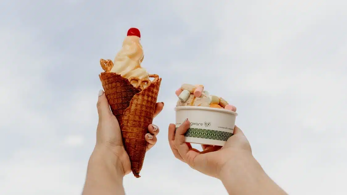 person holding ice cream cone with cone