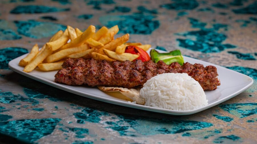 a white plate topped with meat and french fries