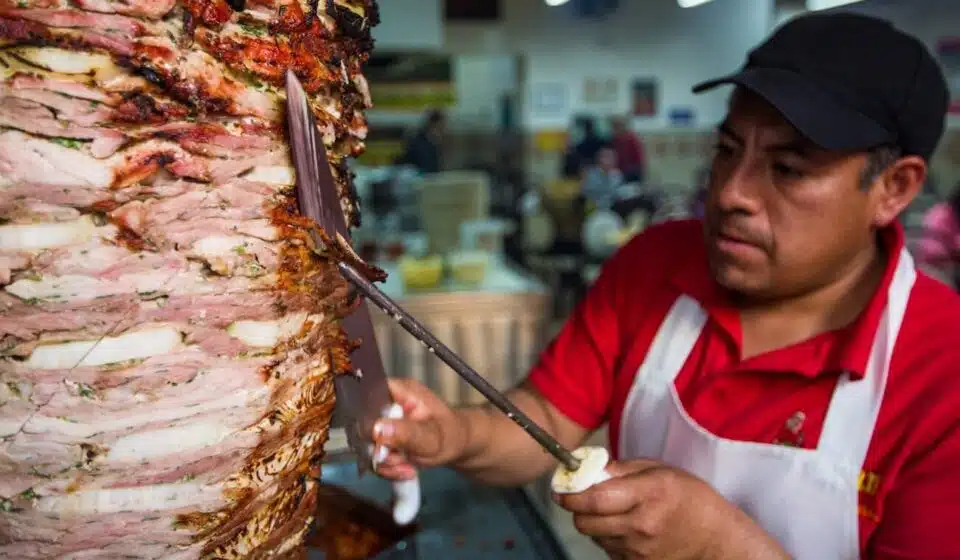 man in red and white polo shirt holding stainless steel fork