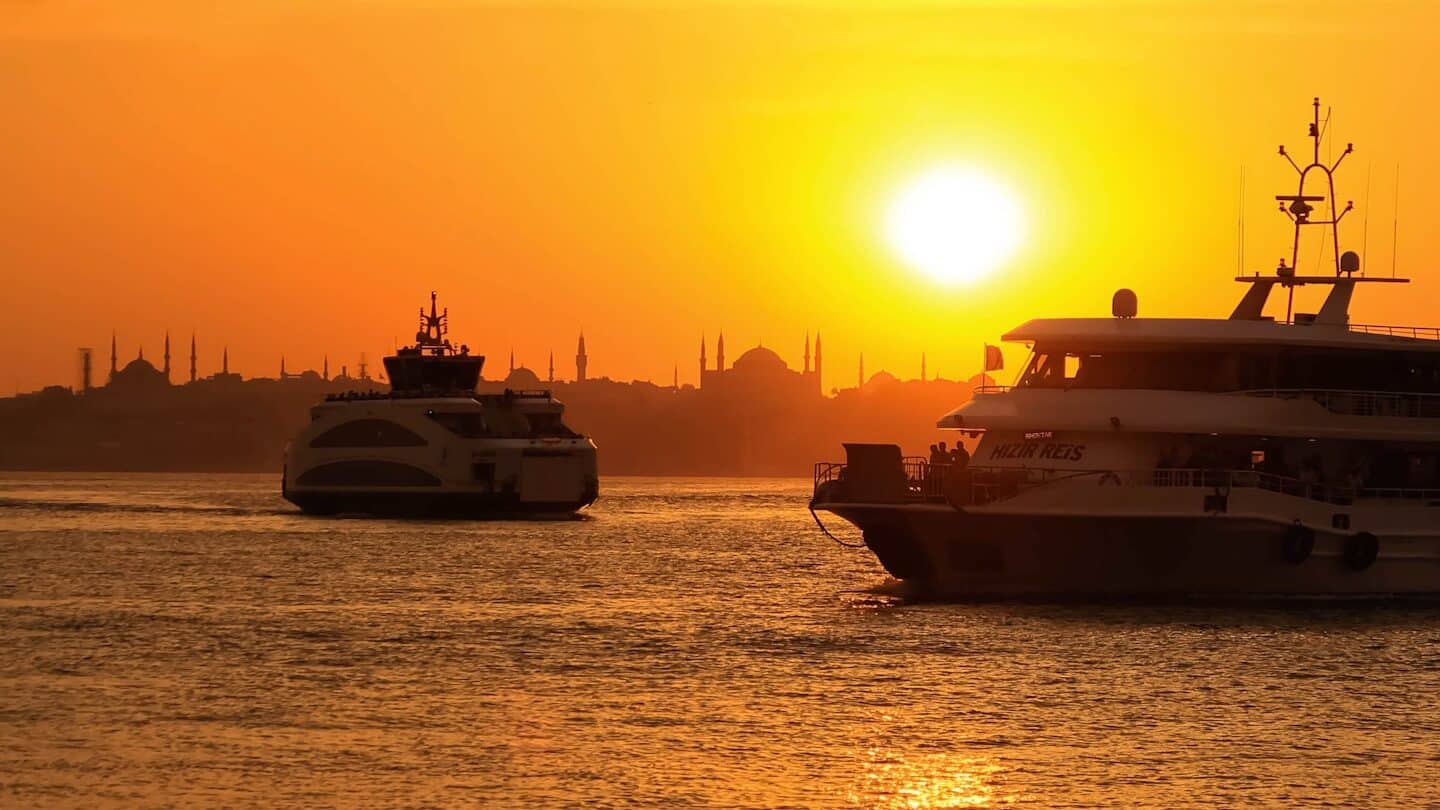 white and black boat on sea during sunset